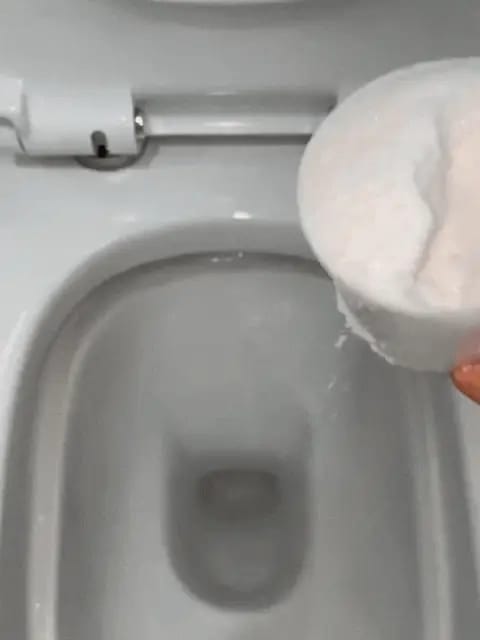 Misurino di polvere bianca versato nella tazza del water